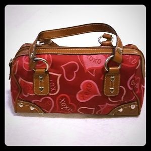 Red purse with tan straps